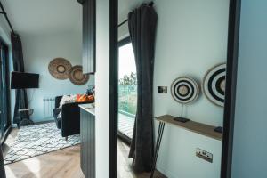 a living room with a door open to a living room at Priory Bay Escapes - Visum in Tenby