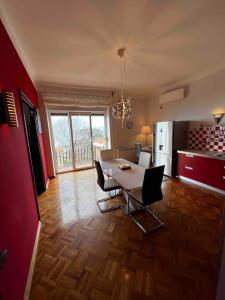 a living room with a table and chairs and a kitchen at Apartment Alessio - sea view in Rijeka +4 photos