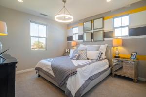 a bedroom with a bed and a desk and windows at NEW! PGA West (Signature!) walk to Stadium Course! in La Quinta