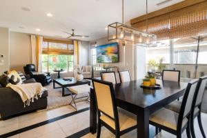 a dining room and living room with a table and chairs at NEW! PGA West (Signature!) walk to Stadium Course! in La Quinta