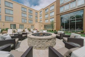 a patio with a fire pit in front of a building at Courtyard by Marriott Nashua in Nashua