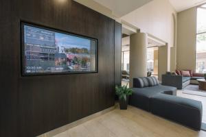 a living room with a flat screen tv on a wall at Courtyard by Marriott Nashua in Nashua