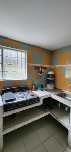 a kitchen with a stove top oven in a kitchen at Casa Campestre Las Margaritas 