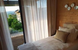 - une chambre avec un lit et une grande fenêtre dans l'établissement Devagar & Devagarinho, à Fafe