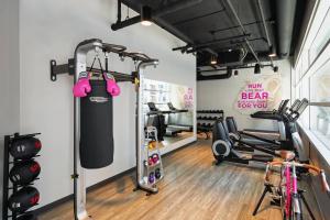 a gym with treadmills and bikes in a room at Moxy Minneapolis Downtown in Minneapolis