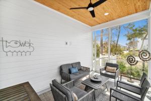 a patio with furniture and a ceiling fan at 30A Beach House - Mira Bella in Rosemary Beach