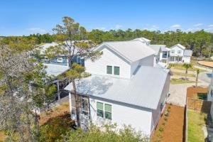 an aerial view of a white house at 30A Beach House - Mira Bella in Rosemary Beach