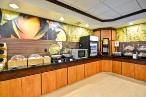 a restaurant with a counter with food on it at Fairfield Inn & Suites Tampa Fairgrounds/Casino in Tampa