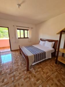 a bedroom with a bed in a room at Pousada Nativos in Baía Formosa