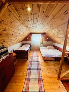 a large room with two beds in a attic at CHATA ŠEFEC holiday resort Východná in Východná