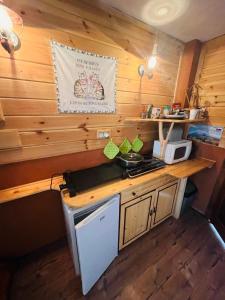 a kitchen with a counter with a stove top oven at CHATA ŠEFEC holiday resort Východná in Východná