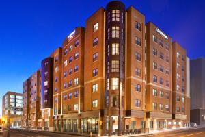 a large brick building on a city street at night at Courtyard by Marriott Syracuse Downtown at Armory Square in Syracuse