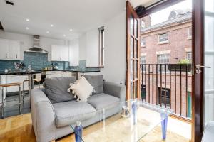 a living room with a couch and a kitchen at Lively Liverpool Living -1BR Flat Near Cavern Club - Pass The Keys in Liverpool