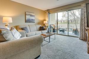 a living room with a couch and a large window at Branson Condo - 3 Mi to Table Rock State Park! in Branson