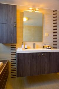 a bathroom with a sink and a mirror at Elounda Blue Waves Residence in Elounda