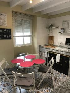 a kitchen with red tables and chairs and a counter at VILLA OLIMAR 