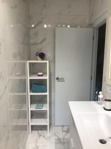 a bathroom with a white cabinet and a sink at VILLA OLIMAR 