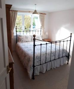 a bedroom with a bed and a window at Entire house, Crambeck,Welburn, near Castle Howard in Welburn