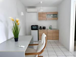 a kitchen with a white table and chairs and a counter at Revel Mykonos in Mikonos