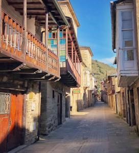 an empty street in an old town with buildings at BenedettaMolinaseca VuT in Molinaseca