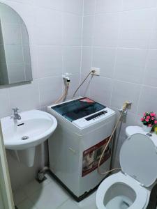 La salle de bains est pourvue d'un lavabo, de toilettes et d'un miroir. dans l'établissement JAZZ DREAM CONDOTEL WITH BALCONY AND SWIMMING POOL, à Manille