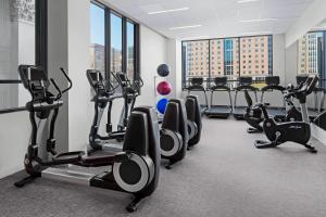 a gym with several treadmills and cardio machines at The Oaklander Hotel, Autograph Collection in Pittsburgh