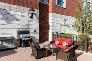 a patio with a table and chairs and a grill at Residence Inn by Marriott Ottawa Airport in Ottawa