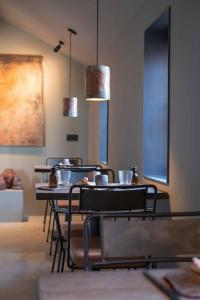 a dining room with tables and chairs and lights at Chambres de Gilberoux in Floreffe