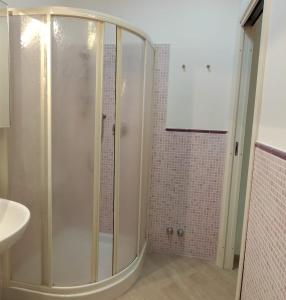 a bathroom with a shower and a white sink at La Casina Tuttomondo in Viareggio