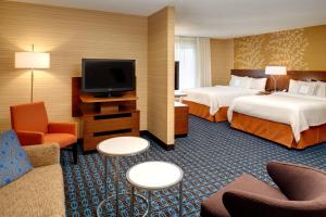 a hotel room with two beds and a flat screen tv at Fairfield Inn by Marriott Frankenmuth in Frankenmuth