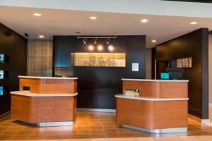 a hotel lobby with wooden counter tops in a room at Courtyard Louisville Downtown in Louisville