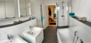 a white bathroom with a sink and a bath tub at RheinWeinBoppard 2 - mit Rheinblick in Boppard +78 photos