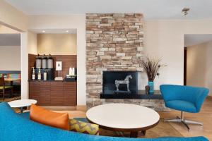 a living room with a table and a fireplace at Fairfield Inn by Marriott Deptford in Deptford
