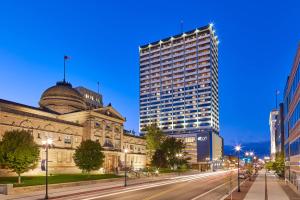 a city street with a tall building in the background at Aloft South Bend in South Bend