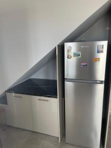 eine Küche mit einem Kühlschrank und einer Theke in der Unterkunft Airport View Apartments in Artemida