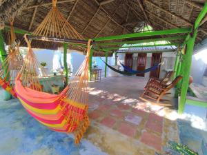 a room with two hammocks in a house at Hostal Casa La Candelaria in Mompós