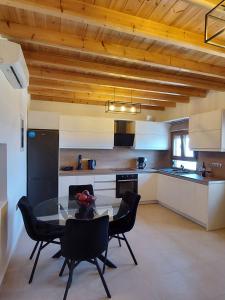 a kitchen with a table and chairs in a room at Villa Natural View in Moutsoúna