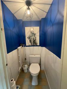 baño con paredes azules y aseo blanco en Le clos de Marissel, en Beauvais