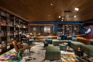 a living room with a couch and chairs and tables at Moxy NYC East Village in New York +56 photos