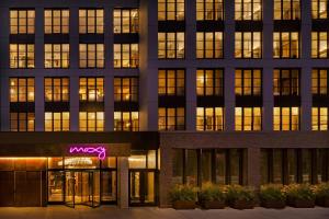 an office building with a neon sign in front of it at Moxy NYC East Village in New York