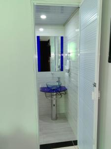 a bathroom with a sink and a mirror at HOTEL VILLA DANIELA in Puerto Triunfo