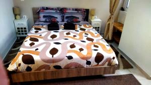 a bed with a cow patterned comforter in a bedroom at DOWNTOWN Mavili's Studio in Corfu Town