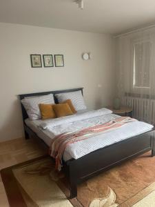 a bedroom with a large bed with orange pillows at MW3 Apartament in Rzeszów