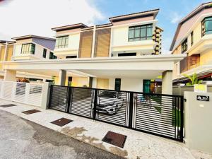 a house with a black fence in front of it at Cozy Family Escape by StayCo - Pool, KTV, Outdoor Cinema & JACUZZI - Just 2 mins to Beach in Batu Ferringhi