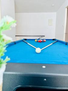 a blue pool table with a cue ball on it at Cozy Family Escape by StayCo - Pool, KTV, Outdoor Cinema & JACUZZI - Just 2 mins to Beach in Batu Ferringhi