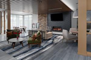 a living room with a couch and a fireplace at Fairfield Inn & Suites by Marriott Lake Geneva in Lake Geneva