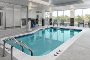 a swimming pool with blue water in a building at Fairfield Inn & Suites by Marriott Lake Geneva in Lake Geneva