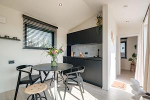 a kitchen and dining room with a table and chairs at B-LESS in Blankenberge
