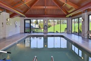 a swimming pool in a house with a wooden ceiling at Fairfield by Marriott Rochester Henrietta/University Area in Henrietta