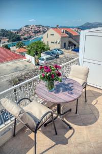 a table and chairs on a balcony with a view at Guesthouse Victoria II in Dubrovnik